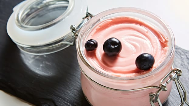 Fresh strawberry yoghurt dessert in glass, selective focus.