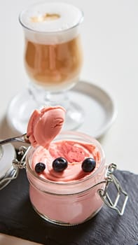 Fresh strawberry yoghurt dessert in glass, selective focus