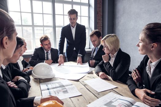 Engineers and businessmen are discussing construction projects in workplace. Construction concept.
