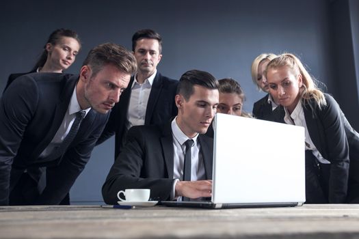 Business team with laptop computer having discussion in office