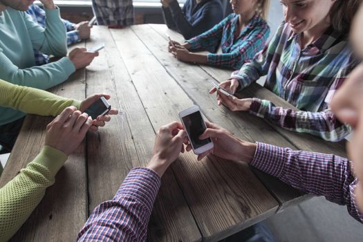 Group of business people using smartphones at work