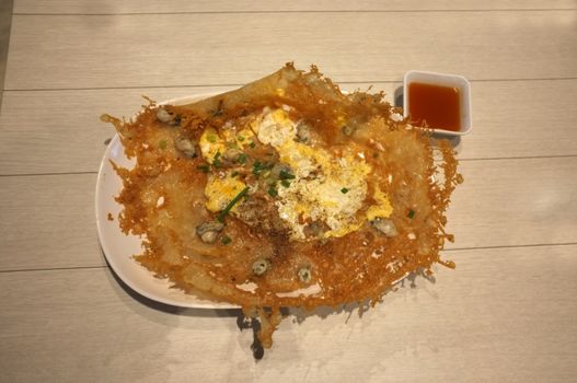 Crisp fried mussel pancakes, Fried oyster with eggs in Rice and Curry Shop at Central Village outlet near Suvarnabhumi , Thailand