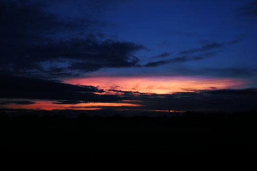 A colorful sunup above a small train station in thailand , Effect saturation