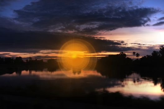 A colorful sunup above a small train station in thailand , Effect lens flare