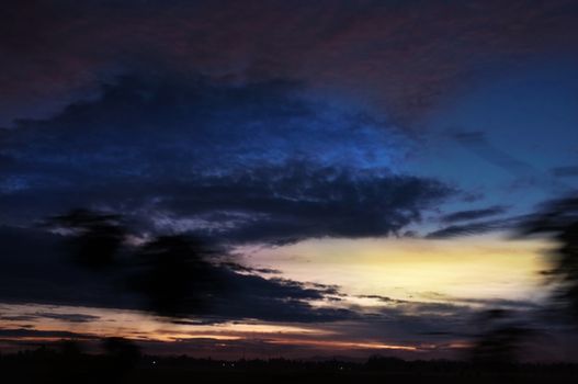 A colorful sunup above a small train station in thailand 