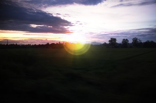 A colorful sunup above a small train station in thailand , Effect lens flare