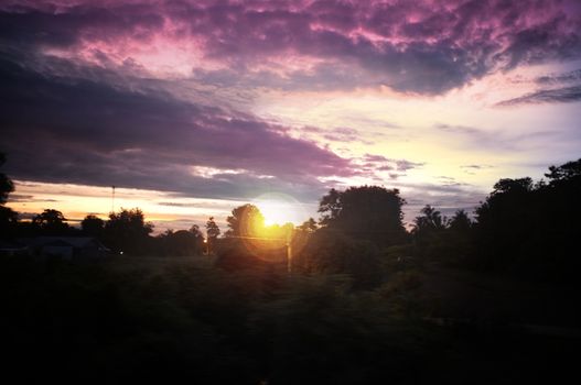 A colorful sunup above a small train station in thailand , Effect lens flare