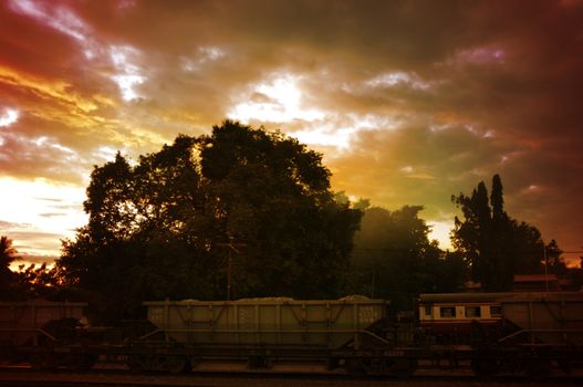 A colorful sunup above a small train station in thailand , Effect Golden light