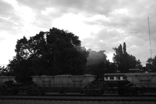 A colorful sunup above a small train station in thailand 
