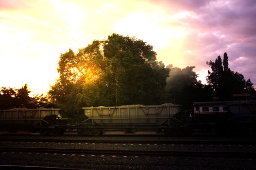 A colorful sunup above a small train station in thailand 
