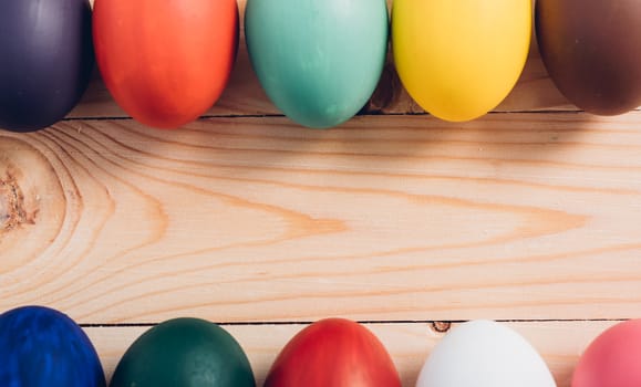 Easter eggs clean frame on wooden background, easter day concept