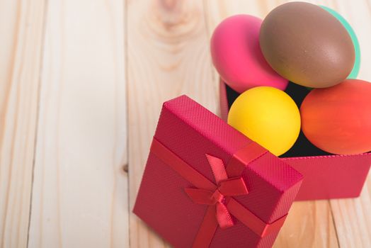 Easter eggs clean in red box gift on wooden background, easter day concept