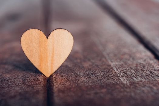 Wood heart stand on wooden background, valentine day concept