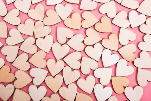 Wood hearts texture on pink background, valentine day concept