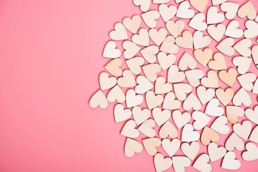 Wood hearts on pink background with copy space, valentine day concept