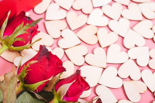 Wood hearts on pink background have a flower rose, valentine day concept