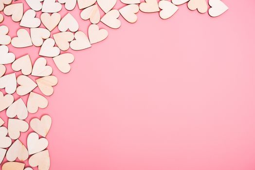 Wood hearts on pink background with copy space, valentine day concept