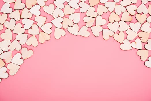 Wood hearts on pink background with copy space, valentine day concept