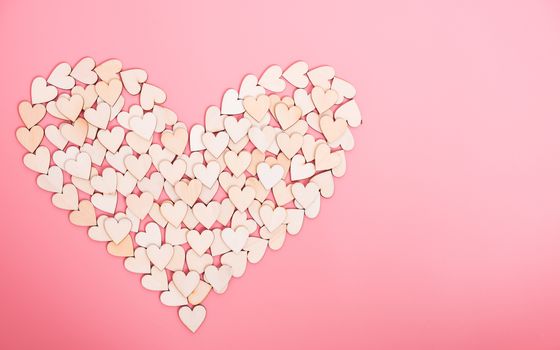 Wood hearts on pink background, valentine day concept