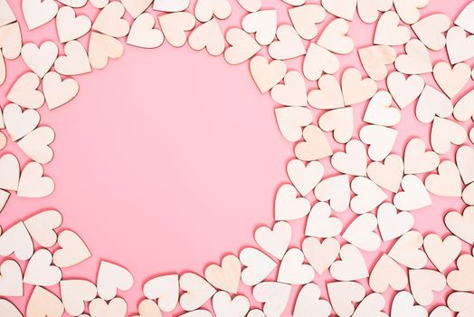 Wood hearts on pink background have sphere copy space, valentine day concept