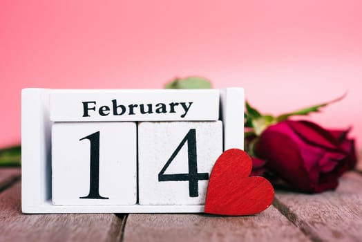 Red wood Hearts and gift box on wooden and pink background, 14 February, valentine day concept