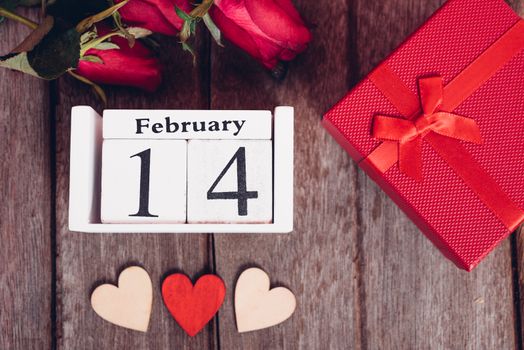 Top view of red wood Hearts and gift box on wooden background, 14 February, valentine day concept