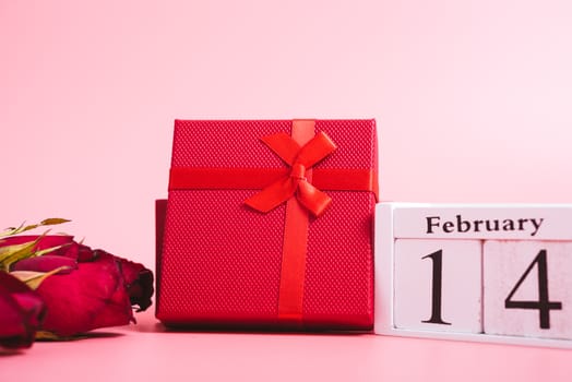 Red wood Hearts and gift box on pink background, 14 February, valentine day concept