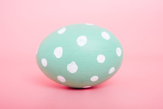 Beautiful Easter Green egg color on pink background, Easter day concept