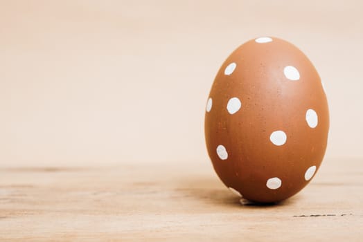 Beautiful Easter Brown egg on wooden background, Easter day concept