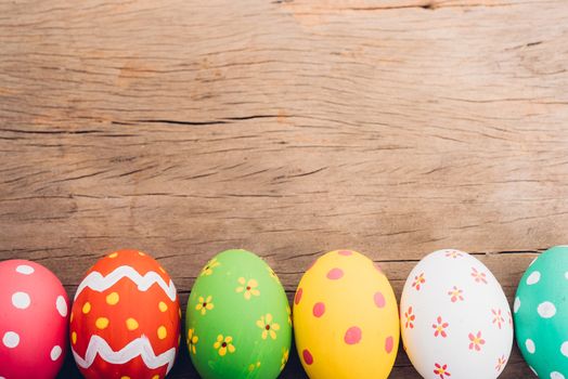 Beautiful Easter multi color egg on wooden background, Easter day concept