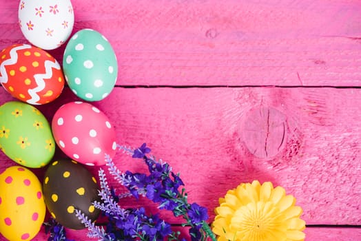 Easter eggs top view on pink wooden background and have copy space for use