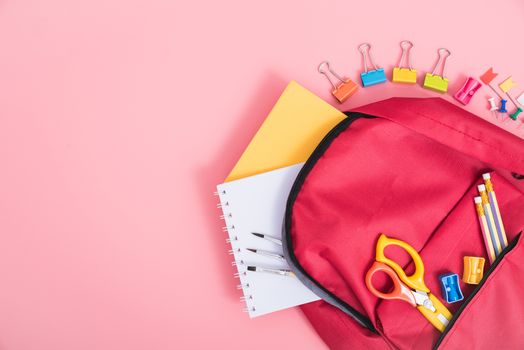 Top view Red bag backpack for education children on pink background back to school concept