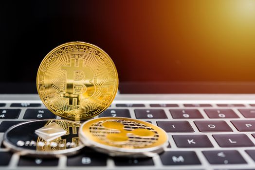 Virtual golden Bitcoin coin currency finance money on computer laptop keyboard