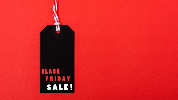 Online shopping, Promotion Black Friday Sale text on black tag on red background.