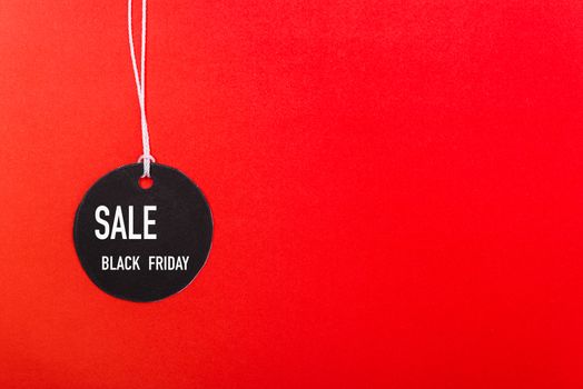 Online shopping Black Friday sale text on Circle Black tag label on red background, with copy space