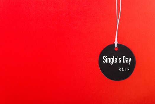 Online shopping Single's day sale text on Circle Black tag label on red background, with copy space