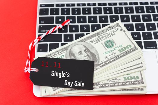 11.11 Online shopping Single's day sale text on Black tag label on laptop computer, with copy space