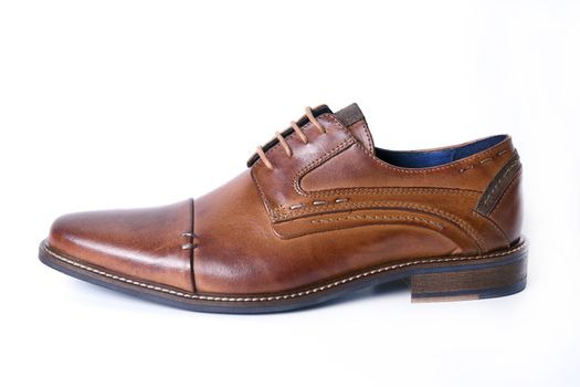 Male brown leather shoe on white background, isolated product, top view.