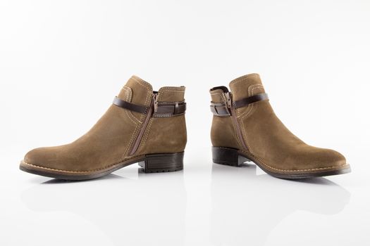 Pair of brown boots on white background, isolated product.