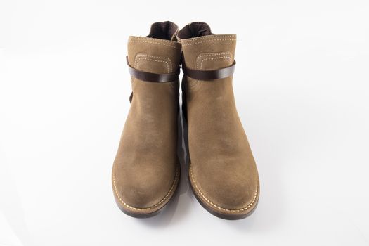 Pair of brown boots on white background, isolated product.