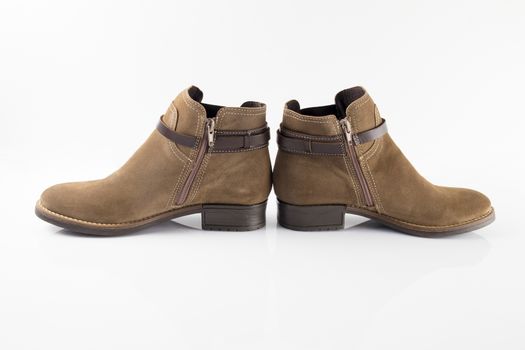 Pair of brown boots on white background, isolated product.