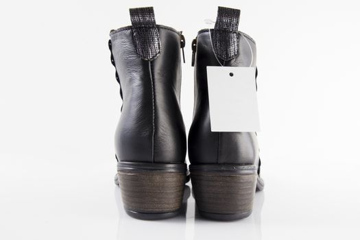 Pair of Female black boots on white background, isolated product.