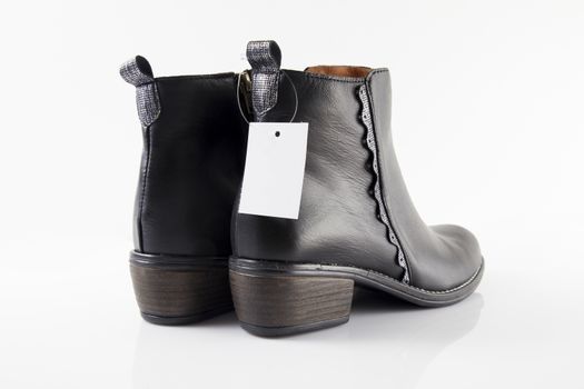 Pair of Female black boots on white background, isolated product.