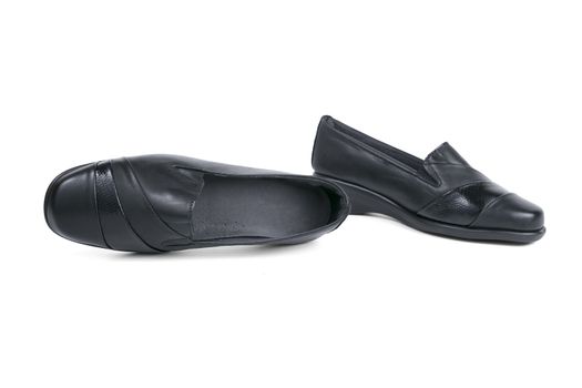 Pair of female black leather shoe on white background, isolated product.