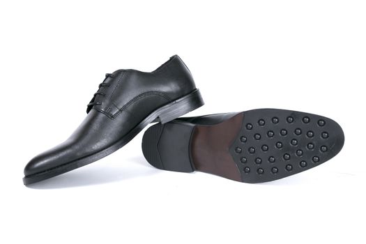 Pair of black shoes on white background, isolated product.