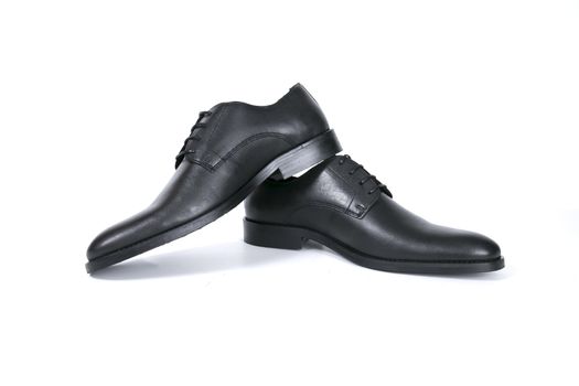 Pair of black shoes on white background, isolated product.