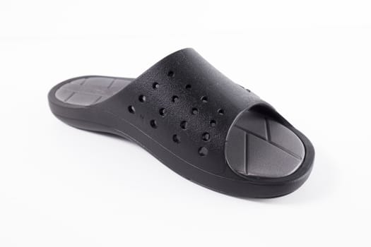 Black slipper on white background, isolated product.