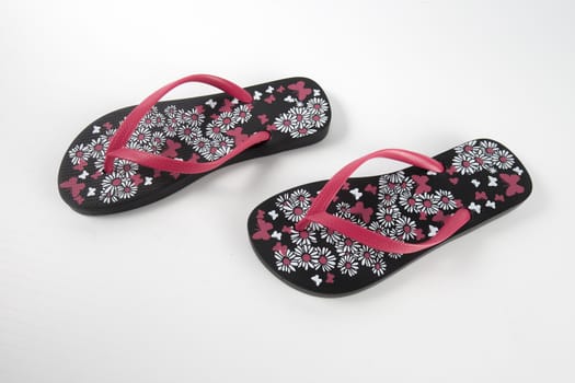 Black and pink rubber slipper on white background, isolated product.