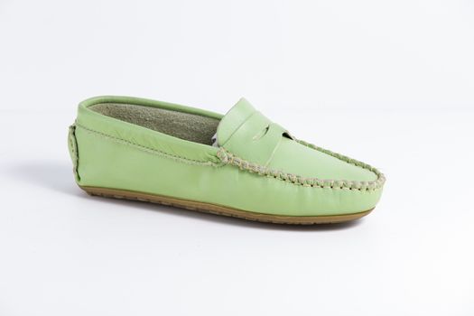 Female green leather shoe on white background, isolated product.