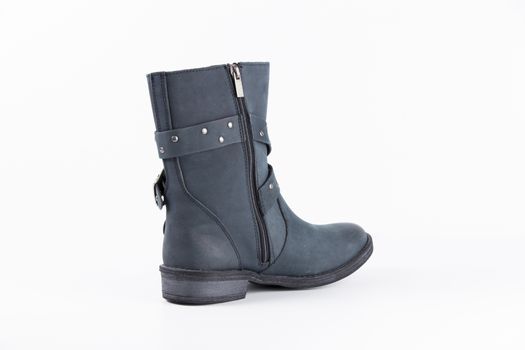 Female blue leather boots, isolated product.